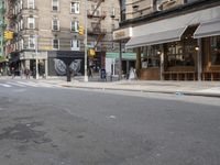 a man is walking on a sidewalk with a suitcase in one hand and the other in the other