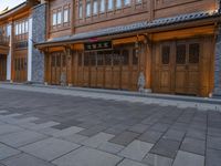 a man walks through the sidewalk of an old chinese city street at night of twilight