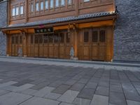 a man walks through the sidewalk of an old chinese city street at night of twilight