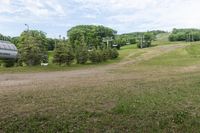 an image of a man standing in the field watching a ski lift move in front