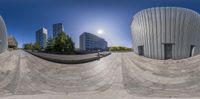 the photo is taken using a fisheye lens of the city of manchester from a skateboard park