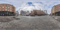 an image of some buildings and sky from the 360 - shooter lens of a street