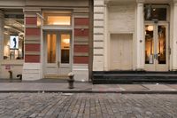 a store front that is bricked in with red bricks on the sidewalk in front of it