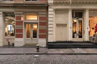 a store front that is bricked in with red bricks on the sidewalk in front of it