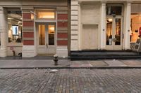 a store front that is bricked in with red bricks on the sidewalk in front of it