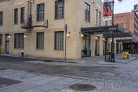 an image of a building that is on the street in front of a store with a sign