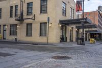 an image of a building that is on the street in front of a store with a sign