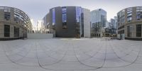 a street full of circular buildings and people walking around it in front of them is a circular