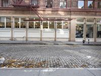 an old fashion store with a lot of windows and doors on one side of the building