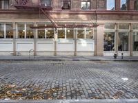 an old fashion store with a lot of windows and doors on one side of the building