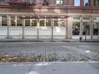 an old fashion store with a lot of windows and doors on one side of the building