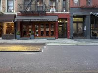 the city is full of different businesses and buildings, as well as a sidewalk with an open fire hydrant