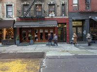 the city is full of different businesses and buildings, as well as a sidewalk with an open fire hydrant