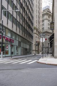 a quiet city street in the heart of a big city in the united states with tall buildings and many signs