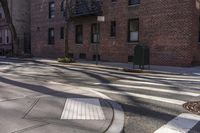 a cross walk in front of some brick buildings with no cars at all on the road