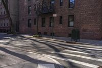 a cross walk in front of some brick buildings with no cars at all on the road