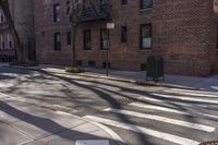 a cross walk in front of some brick buildings with no cars at all on the road