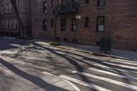 a cross walk in front of some brick buildings with no cars at all on the road