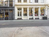 street corner with a building and stores on either side of the road where it stands