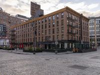 a building in an urban setting in new york, ny, usa with old brick buildings and a cobblestone sidewalk