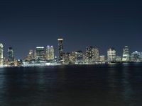 a night time view of the city skyline of new york, ny from lower manhattan