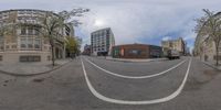 an intersection of two buildings and a car park and a street as seen through the fisheye