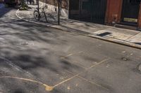 a paved street with yellow marker in the middle and bikes parked on both sides of it