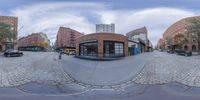 this is a photo of a street that has a fisheye lens showing the street and buildings