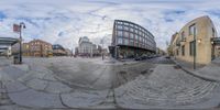 a 360 - lens photo of a city street scene with people walking by the building