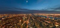 view from the top of rockefeller tower at night, looking down on new york city