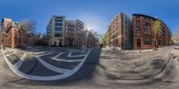 several buildings in the same side of a city street and a 360 - ray lensed on them