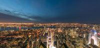 the view from top of the empire building of the city at night with lights on