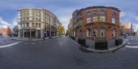 a view of a street intersection and buildings from a fish eye lens angle shot with an angled lens