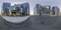 view down a street in front of tall buildings, from the base of a curved road