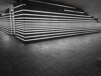 an image of a long wall lit up with neons in black and white,
