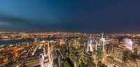 a night time view of a large city with lights all over it's buildings