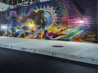 a person jumping a skateboard over a skate board stand in front of a graffiti covered wall