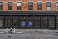 a store with a sign that says public library on it in front of a brick building