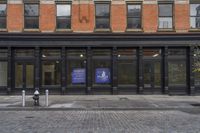 a store with a sign that says public library on it in front of a brick building