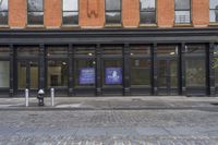 a store with a sign that says public library on it in front of a brick building