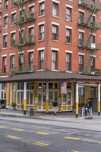 a small restaurant on the corner of a street that has a car parked at an intersection