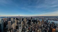 there are many tall buildings near the water and city streets of the capital of new york