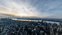 some buildings water and a large body of water at dusk on top of a building