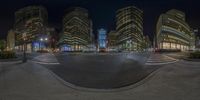 a city street with some very tall buildings and lights at night sky time, the image is distorted