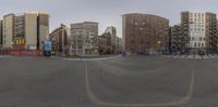 the street and buildings are blurry in this fish eye view picture from an angle