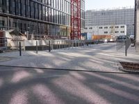 a manhole sitting in the middle of an urban street near a building that is being built