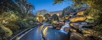 the walkway leads up to a waterfall in this backyard area of a mansion in pasadena