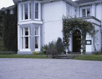 Mansion with Tree-Lined Driveway in Residential Area 001