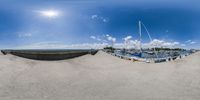 there is a fish eye view of a marina beach with boats and sand in the water