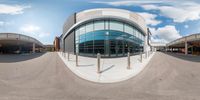 a circular panoramic view of a building near a roadway on an outdoor street